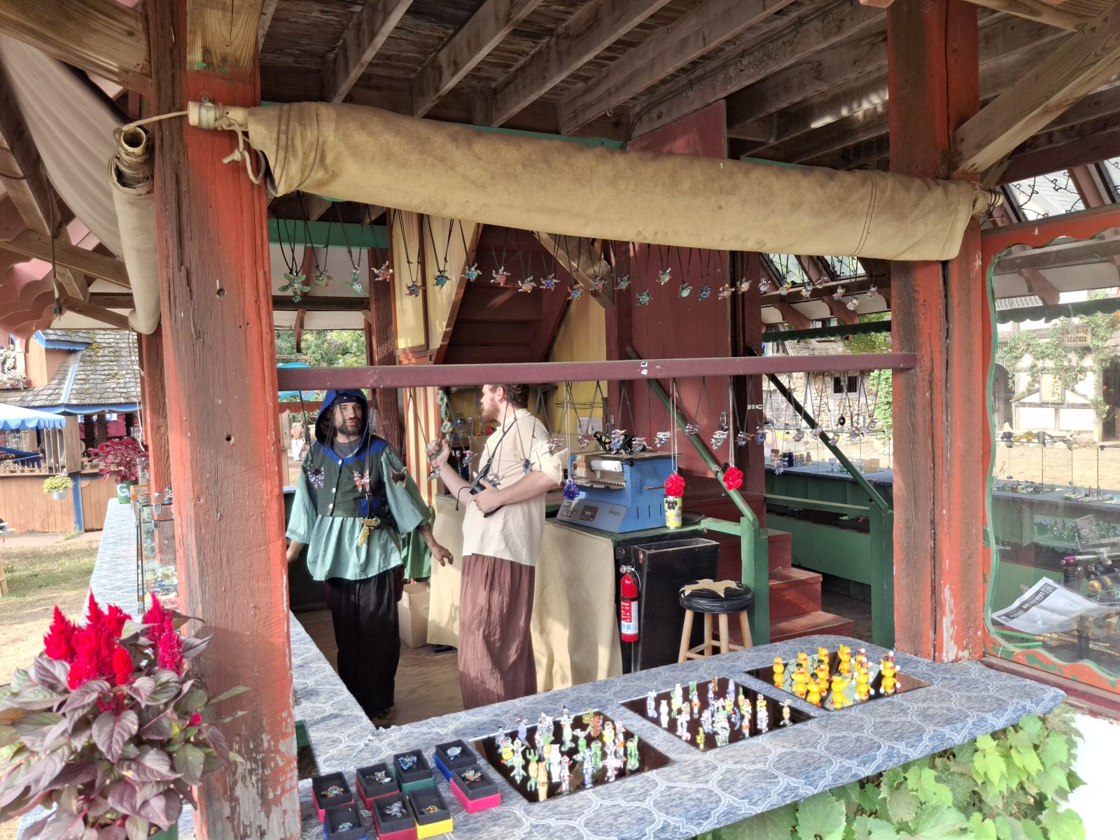 Glass pendants hanging in the booth with artists in costume